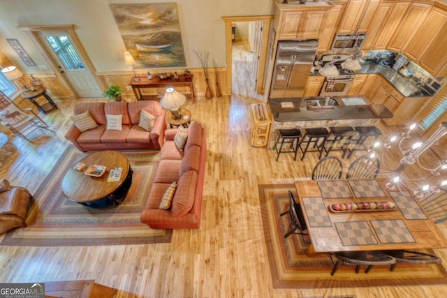 living room with a chandelier and light hardwood / wood-style floors