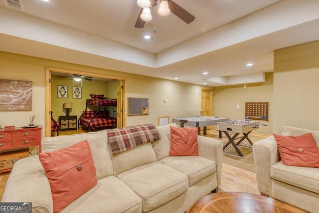 living room featuring light wood-type flooring and ceiling fan