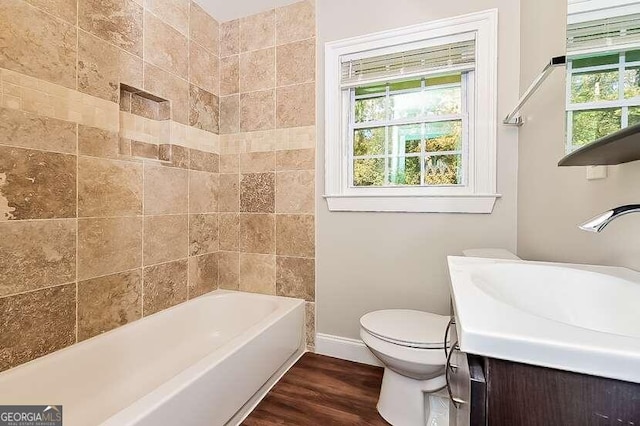 bathroom with wood-type flooring, vanity, and toilet