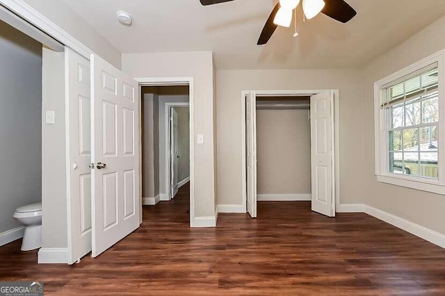 unfurnished bedroom with ceiling fan and dark hardwood / wood-style floors