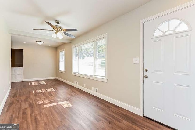 foyer entrance featuring ceiling fan and dark wood-type flooring