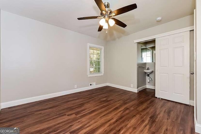 unfurnished bedroom featuring a closet, ceiling fan, and dark wood-type flooring