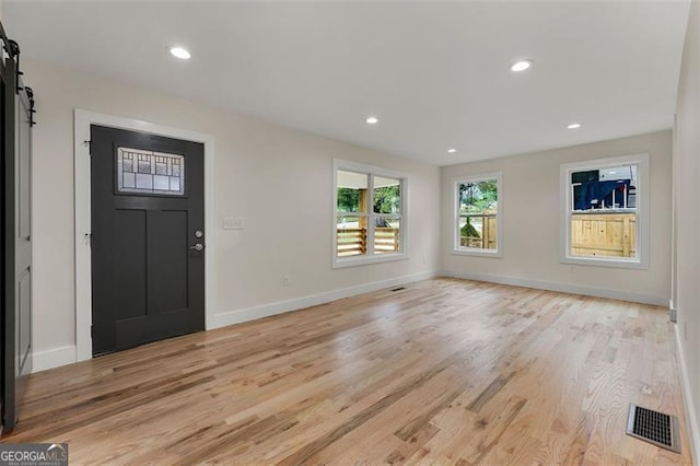 entrance foyer featuring a barn door and light hardwood / wood-style flooring