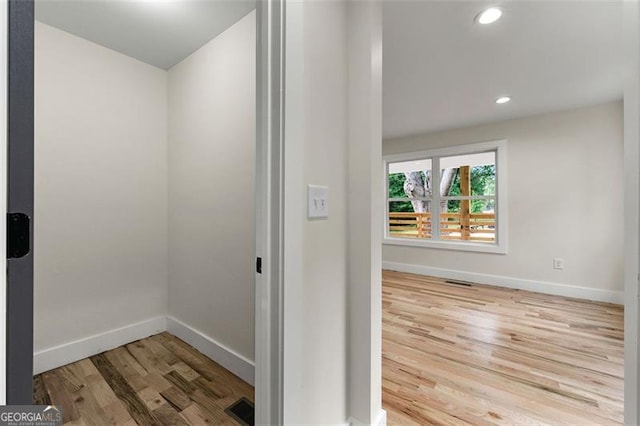 hall with hardwood / wood-style flooring