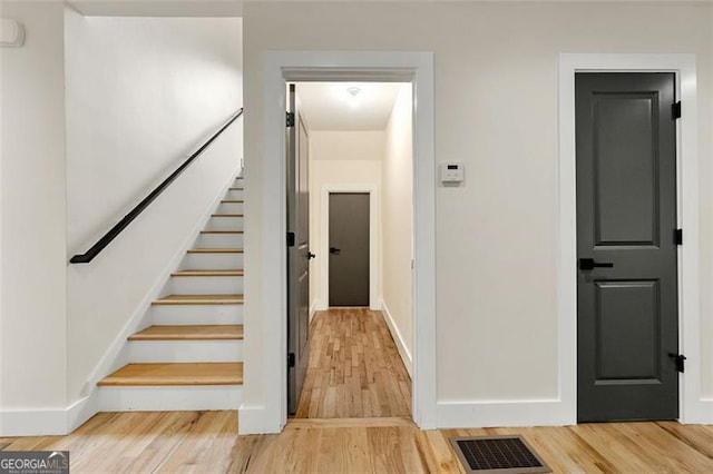 stairway featuring wood-type flooring