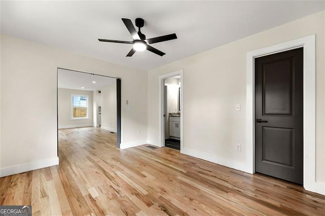 unfurnished room with light wood-type flooring and ceiling fan