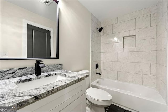 full bathroom with tile patterned flooring, vanity, toilet, and tiled shower / bath