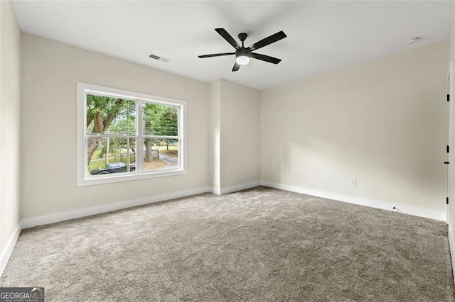 spare room featuring carpet floors and ceiling fan