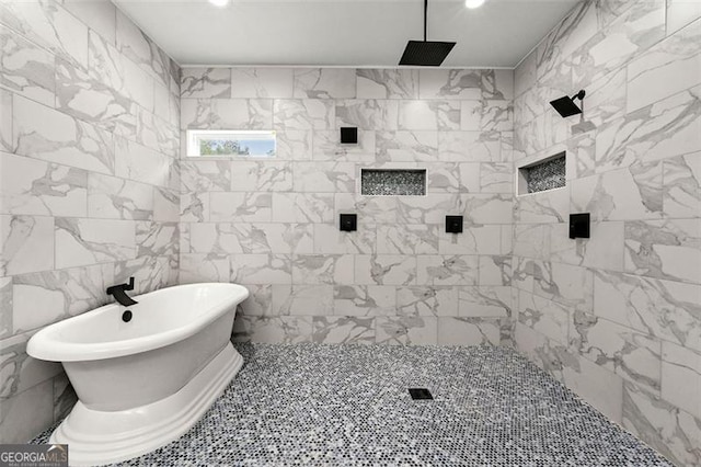 bathroom featuring plus walk in shower and tile walls