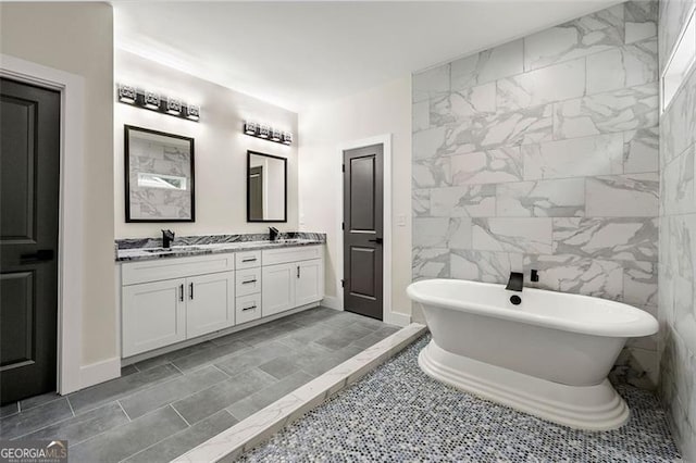 bathroom featuring vanity, tile walls, and a washtub