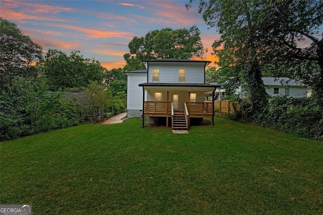 back house at dusk with a yard