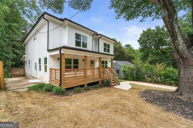 back of house featuring a lawn and a patio