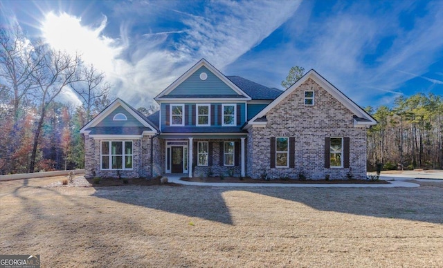 craftsman-style home featuring brick siding