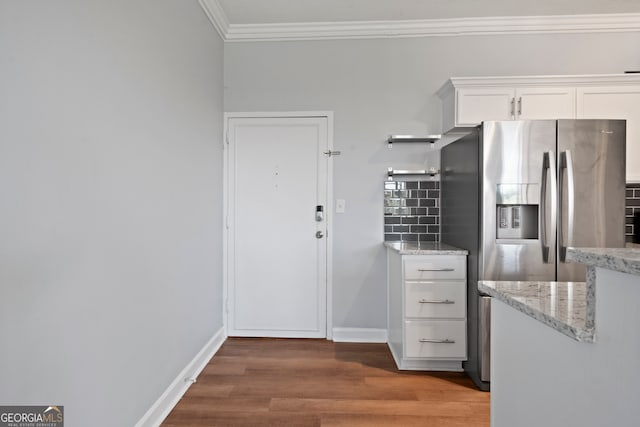 kitchen featuring decorative backsplash, white cabinets, light stone countertops, dark hardwood / wood-style flooring, and stainless steel fridge with ice dispenser