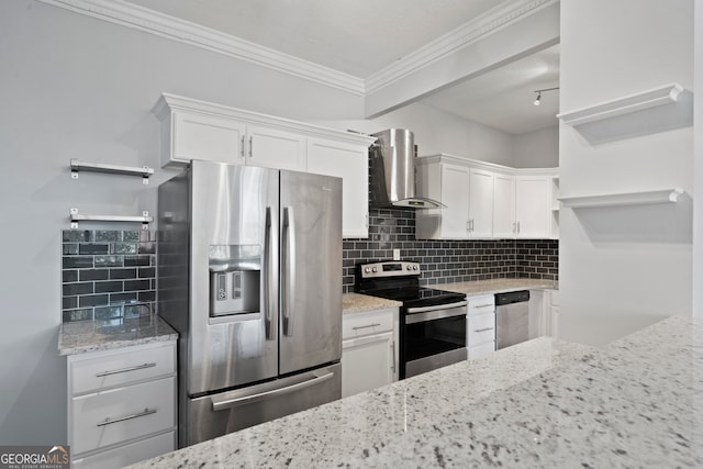 kitchen featuring white cabinets, stainless steel appliances, light stone countertops, and wall chimney range hood