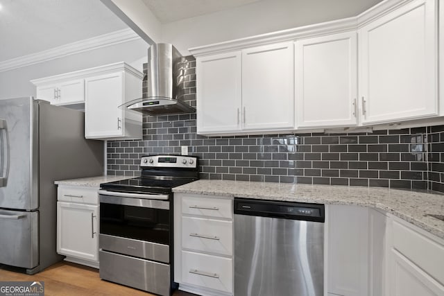 kitchen featuring light hardwood / wood-style floors, wall chimney exhaust hood, white cabinetry, and stainless steel appliances