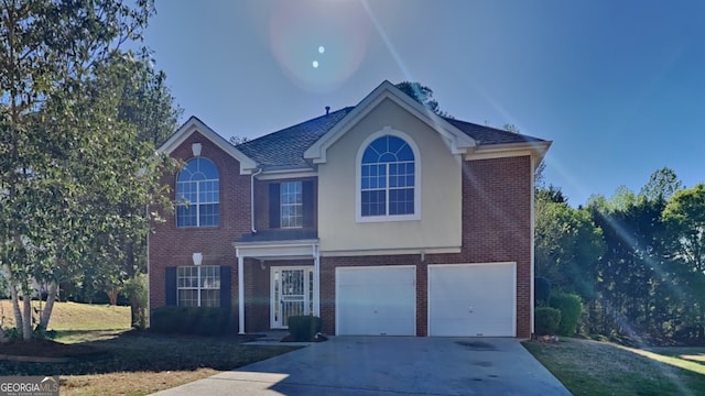 view of front property with a garage and a front yard