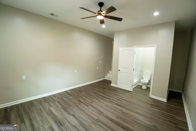 unfurnished bedroom featuring ensuite bathroom, dark hardwood / wood-style floors, and ceiling fan