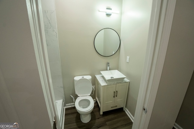 bathroom featuring vanity, hardwood / wood-style floors, and toilet