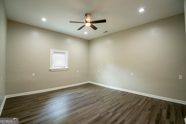 unfurnished room with dark hardwood / wood-style floors and ceiling fan