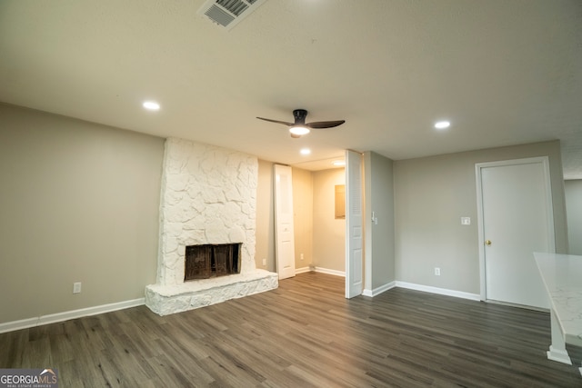 unfurnished living room featuring dark wood-type flooring, a fireplace, and ceiling fan