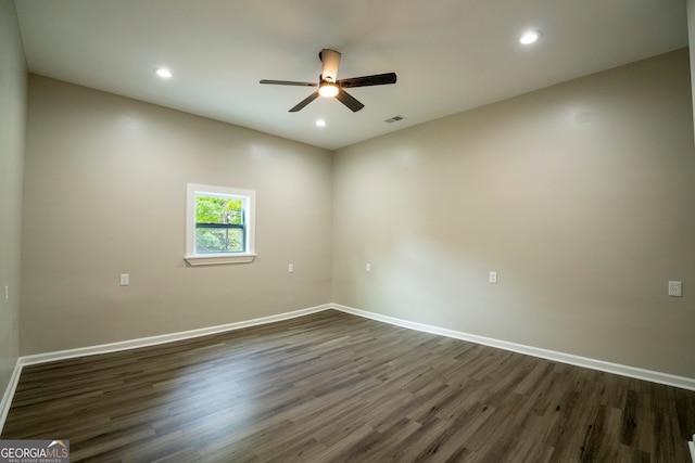 spare room with dark wood-type flooring and ceiling fan