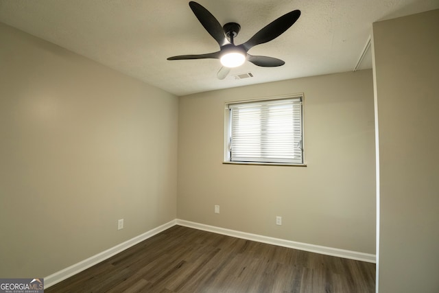 empty room with ceiling fan, a textured ceiling, and dark hardwood / wood-style flooring