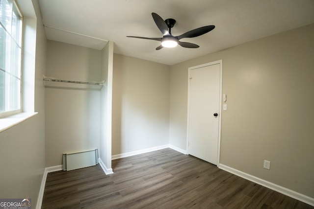 unfurnished bedroom featuring a closet, ceiling fan, and dark hardwood / wood-style floors