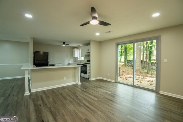 unfurnished living room with dark hardwood / wood-style floors, sink, and ceiling fan