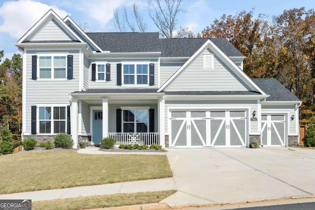 craftsman-style home featuring a front lawn, a porch, and a garage