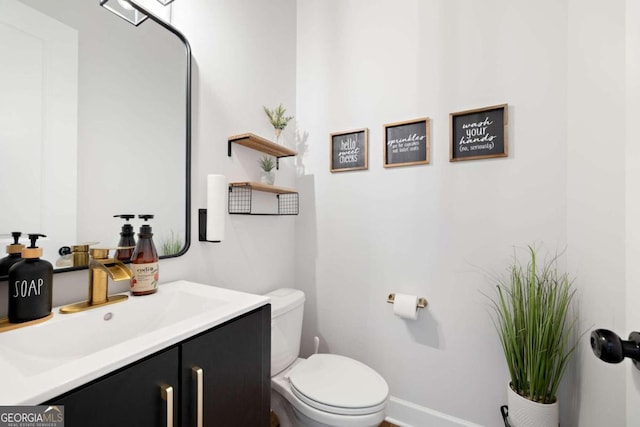 bathroom featuring vanity and toilet