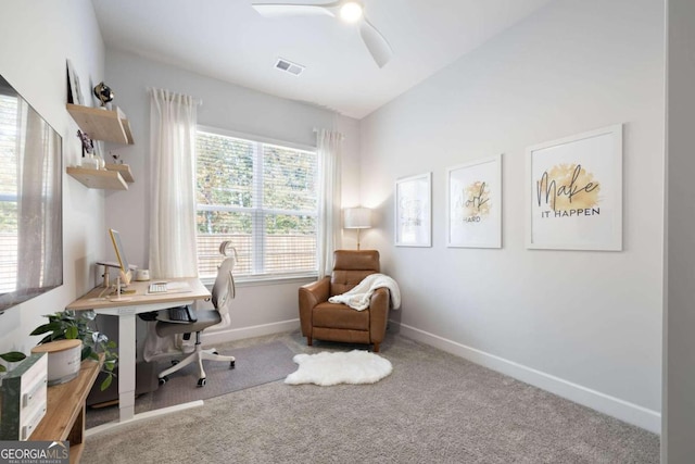 carpeted home office with lofted ceiling and ceiling fan