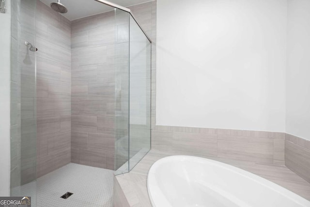 bathroom with separate shower and tub