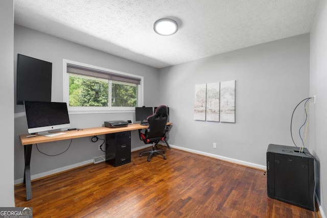 office space featuring a textured ceiling and dark hardwood / wood-style flooring