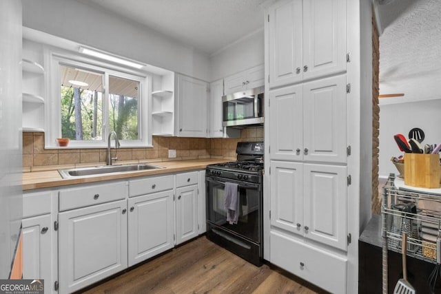 kitchen with white cabinets, a textured ceiling, black range with gas cooktop, and dark hardwood / wood-style flooring