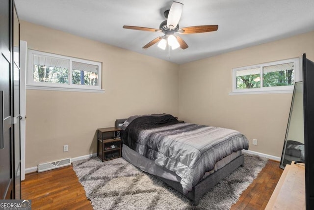 bedroom with ceiling fan and dark hardwood / wood-style floors