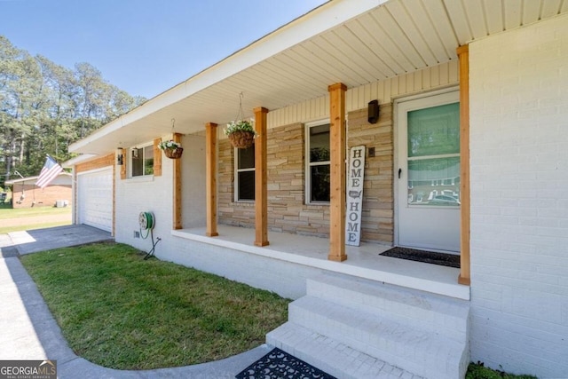 doorway to property featuring a porch and a garage