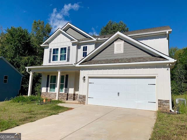 craftsman-style house featuring a front yard, a garage, and a porch