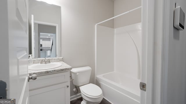 full bathroom featuring washtub / shower combination, vanity, and toilet