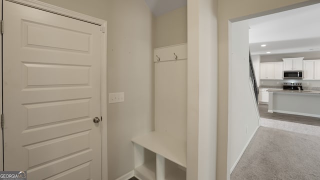 mudroom featuring light carpet