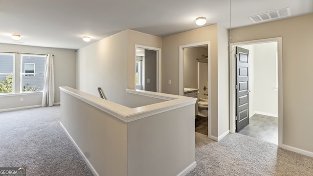 hallway with carpet flooring