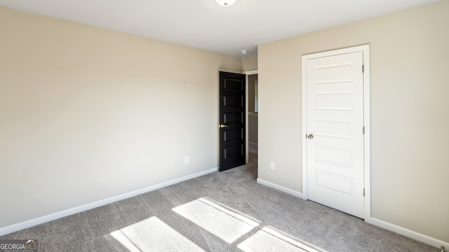 unfurnished bedroom with light carpet and a closet