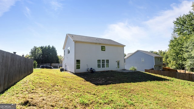 back of property featuring a lawn