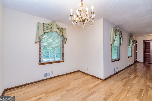 interior space with wood-type flooring and a notable chandelier