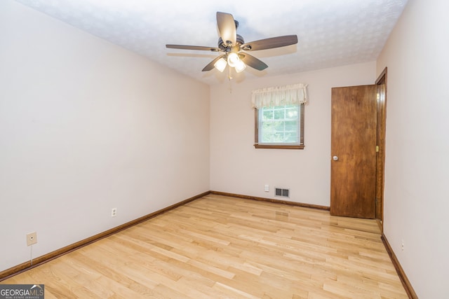 empty room featuring ceiling fan and light wood-type flooring