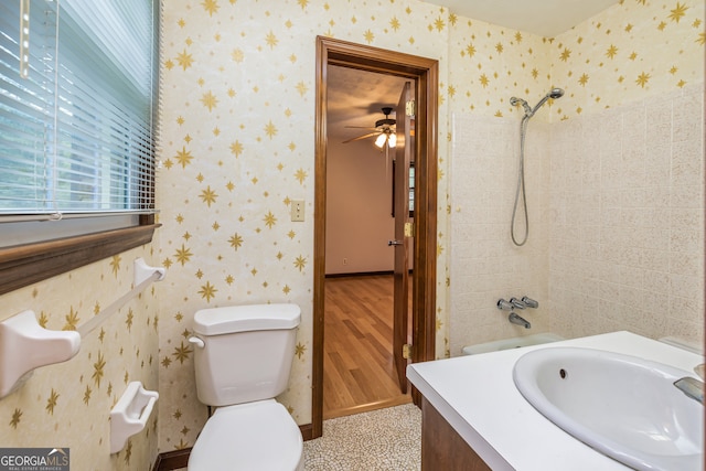 bathroom featuring tiled shower, vanity, toilet, and hardwood / wood-style flooring