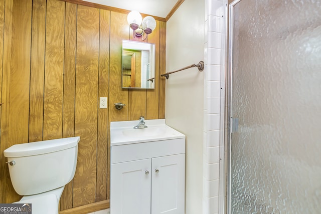 bathroom with vanity, wood walls, an enclosed shower, and toilet