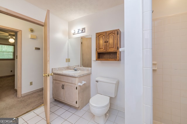 bathroom featuring a textured ceiling, tile patterned flooring, vanity, and toilet