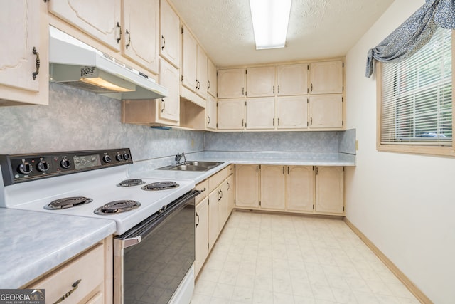 kitchen with a textured ceiling, sink, and electric range