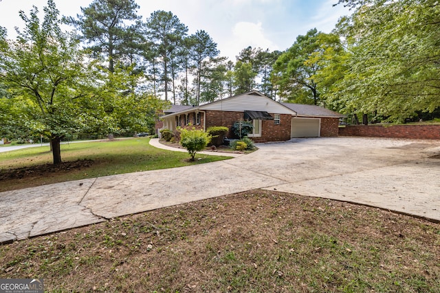 ranch-style home featuring a garage and a front lawn